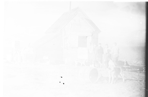 Image of Hunters' hut, people, dogs, supplies